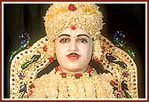 Shri Harikrishna Maharaj adorned with flowers