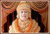 Shri Shastriji Maharaj adorned with flowers at the Yagnapurush Smruti Mandir