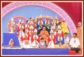 Swamishri with kishores after performing a traditional dance