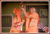 With kartals in hand, Swamishri in a divine mood joins Pujya Ghanshyamcharan Swami while he dances