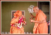 With kartals in hand, Swamishri in a divine mood joins Pujya Ghanshyamcharan Swami while he dances