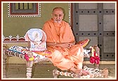 Swamishri with Shri Harikrishna Maharaj seated on a khatli