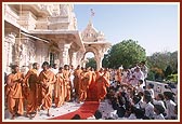 Swamishri showers flower petals and blesses the students of Pramukh Swami Vidya Mandir on the first day of their annual exam