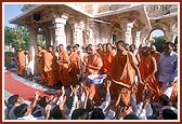 Swamishri showers flower petals and blesses the students of Pramukh Swami Vidya Mandir on the first day of their annual exam