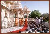 Swamishri showers flower petals and blesses the students of Pramukh Swami Vidya Mandir on the first day of their annual exam