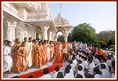 Swamishri blesses a balak who marches besides him