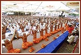 The parshads and sadhus hold the janois during the yagnopavit ceremony