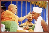  Swamishri smears chandan as part of the parshad diksha rituals