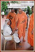 Swamishri blesses an ailing devotee