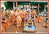 During Rath Yatra festival Swamishri performs pujan of Shri Harikrishna Maharaj on the mandir grounds in Amdavad