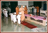 Children (shishus) dressed as senior citizens walk with Swamishri as he arrives for their evening program