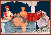 A child shows Swamishri a reference from the Vachanamrut