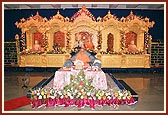 Swamishri during his morning puja with the decorated sinhasan in the backdrop