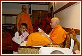 Swamishri talks to the child, gives him prasad...