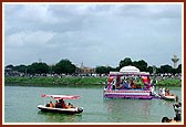 Swamishri and senior sadhus with Thakorji and Shri Ganeshji in a motorboat. Five artis and pradakshinas were performed