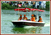 Swamishri and senior sadhus with Thakorji and Shri Ganeshji in a motorboat. Five artis and pradakshinas were performed