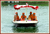 Swamishri and senior sadhus with Thakorji and Shri Ganeshji in a motorboat. Five artis and pradakshinas were performed