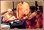 Swamishri happily gives prasad to a fat balak