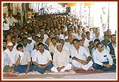 Devotees listening during the satsang assembly