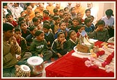 Swamishri performs his morning puja in the presence of students who sing bhajan, sloks and verses