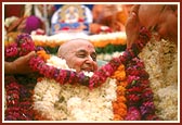 Swamishri is honored with a flower shawl