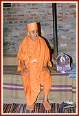  Swamishri seated during an assembly...