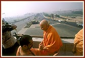 Swamishri observes the Akshardham site from the newly built flyover built on national Highway Number 28