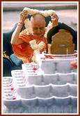 Swamishri is honored with a sanctified garland of Shri Harikrishna Maharaj