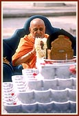 Swamishri is honored with a sanctified garland of Shri Harikrishna Maharaj