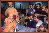 At Chennai airport Swamishri is engaged in a dialogue with the London youths who offer their services in car parking at the London Mandir&nbsp;