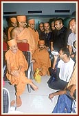 At Chennai airport Swamishri is engaged in a dialogue with the London youths who offer their services in car parking at the London Mandir&nbsp;