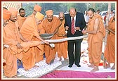 Swamishri and Shri P. D. Patel, the sponsorer of the residential school, perform the foundation-stone laying rituals