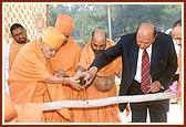 Swamishri and Shri P. D. Patel, the sponsorer of the residential school, perform the foundation-stone laying rituals 
