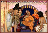 Swamishri plays the 'damru' after the youths perform a dance in honor of Lord Shiva during the Shivratri festival celebration