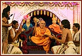 Swamishri plays the 'damru' after the youths perform a dance in honor of Lord Shiva during the Shivratri festival celebration