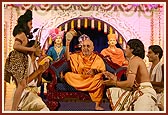 Swamishri plays the 'damru' after the youths perform a dance in honor of Lord Shiva during the Shivratri festival celebration