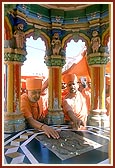 Touching Shriji Maharaj's footprint at the shrine in the mandir pradakshina