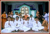 Swamishri blesses and encourages the gurukul students who sang bhajans 