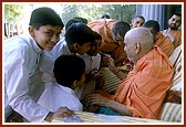 Swamishri blesses and encourages the gurukul students who sang bhajans 