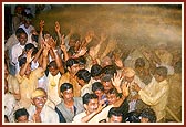 Volunteers rejoice on being blessed with the divine spray of colored water