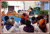 Devotees of Badalpur play the traditional trumpets during Swamishri's morning puja