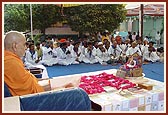 Devotees of Badalpur play the traditional trumpets during Swamishri's morning puja