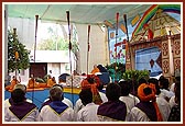 Devotees of Badalpur play the traditional trumpets during Swamishri's morning puja