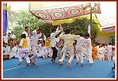 Balaks and youths dance to the tune of a devotional song during Swamishri's puja