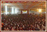 Swamishri seated in public assembly