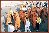 Sadhus walk during the procession through the streets of Nadiad