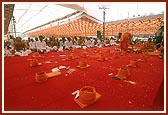 The parshads leave the stage to change from their white robes into their saffron robes