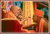 Swamishri blesses and gives the guru mantra to the newly initiated sadhus 