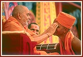 Swamishri blesses and gives the guru mantra to the newly initiated sadhus