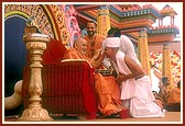Swamishri blesses and gives the guru mantra to the newly initiated parshads